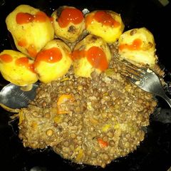 A picture of Roast potatoes served with lentils.