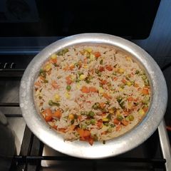 A picture of Vegetable rice, fried chicken and steamed cabbage.