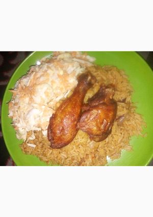 A picture of Jollof Rice, coslow and fried chicken.