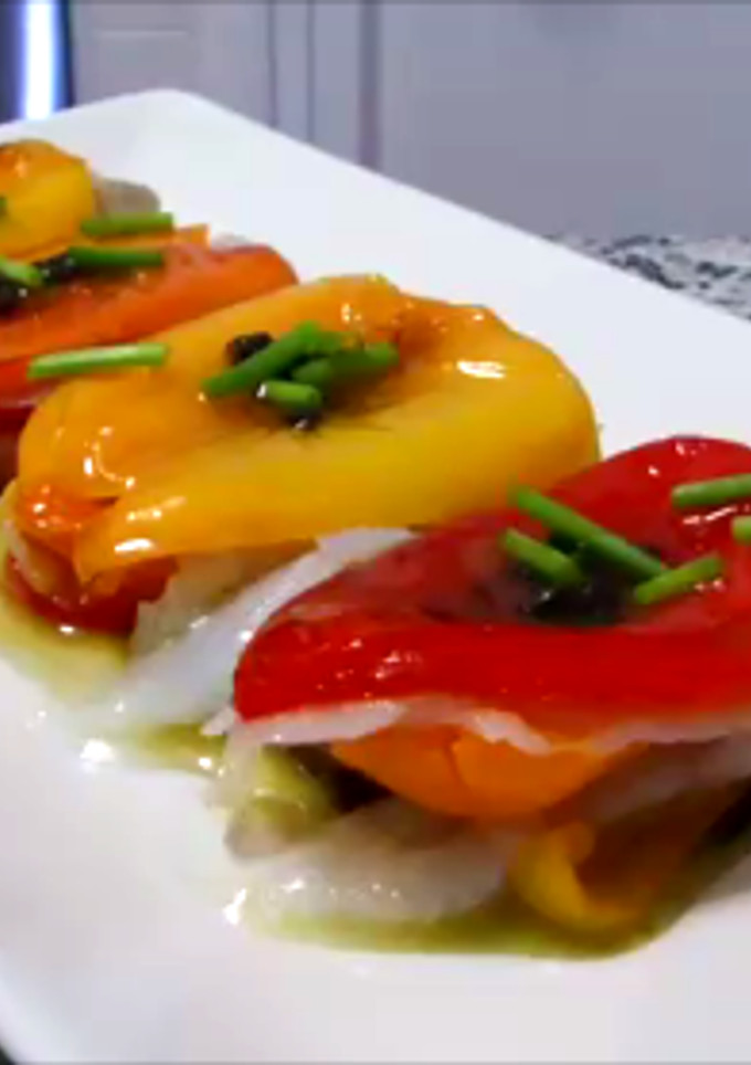 Una foto de Milhojas de pimientos tricolor y bacalao con salsa de aceitunas negras