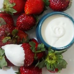 A picture of Homemade whipped cream with Strawberries.