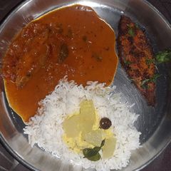 A picture of Fish thali - Rice with Fish curry, fish fry, and spiced buttermilk.
