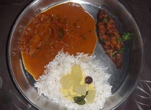 A picture of Fish thali - Rice with Fish curry, fish fry, and spiced buttermilk.