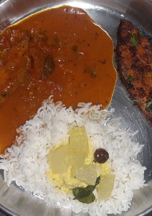 A picture of Fish thali - Rice with Fish curry, fish fry, and spiced buttermilk.