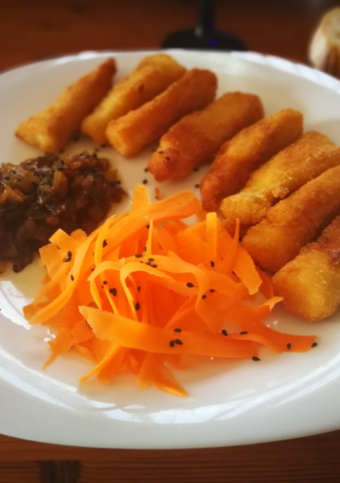 Una foto de Bastoncillos de perca empanados con cebolla caramelizada