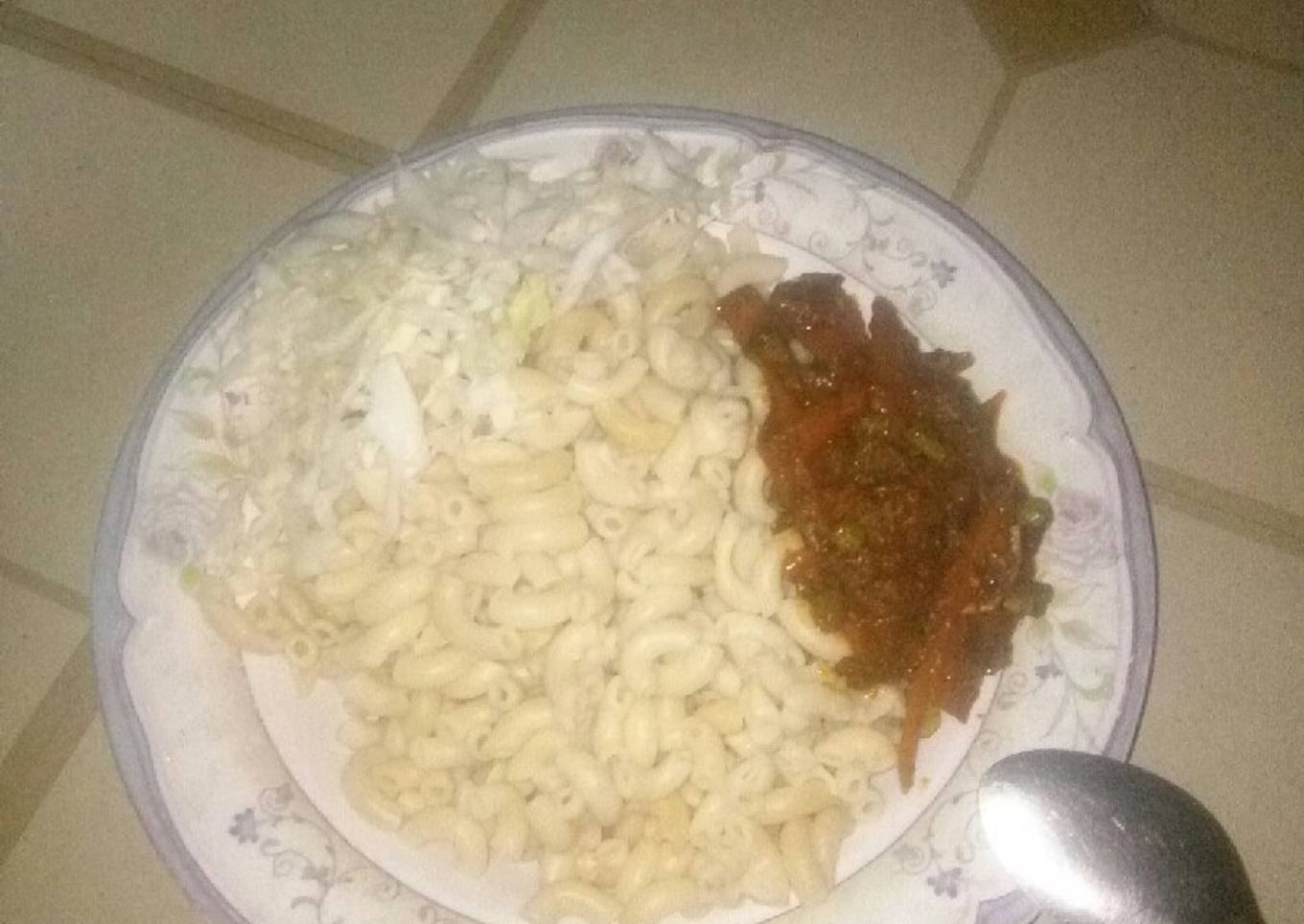 Macaroni paster serve with vegetables source nd cabbage