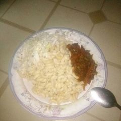 A picture of Macaroni paster serve with vegetables source nd cabbage.