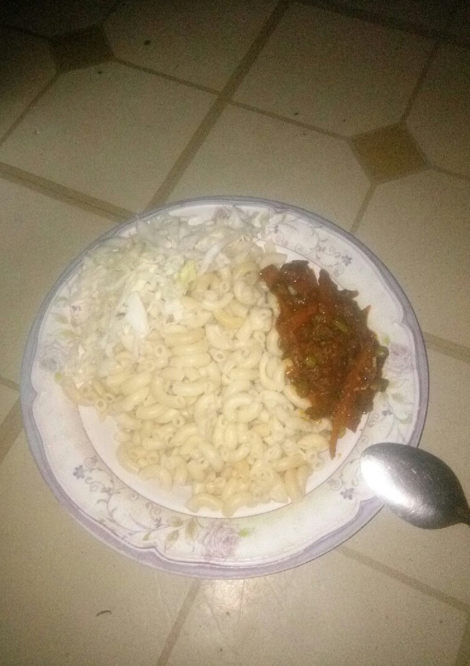 A picture of Macaroni paster serve with vegetables source nd cabbage.