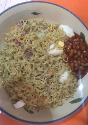 A picture of Noodles and baked Beans.