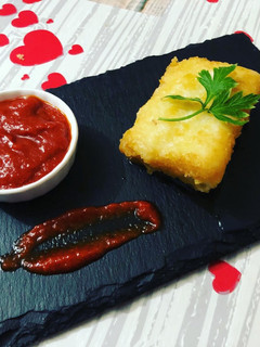 Una foto de Bacalao con tomate frito