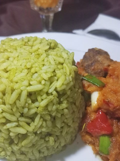 A picture of Green rice and Caropina sauce.