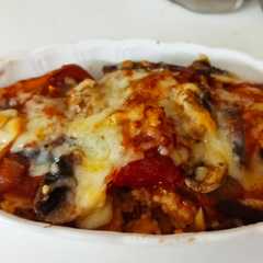 A picture of Baked Rice With Tomato Sauce and Cheese.