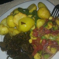A picture of Deep fried potatoes and pan fried liver and kachumbari.