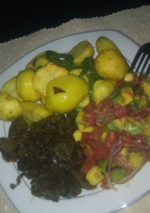 A picture of Deep fried potatoes and pan fried liver and kachumbari.