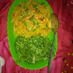 A picture of Jollof rice with salad.