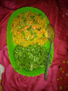 A picture of Jollof rice with salad.