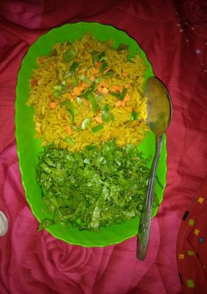 A picture of Jollof rice with salad.