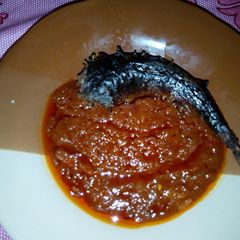 A picture of Smoked fish with Fresh Tomatoes Sauce.