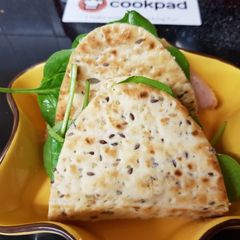 A picture of Flat multiseed Bread, with Ham,Spinach, Tomato & Soft Cheese.