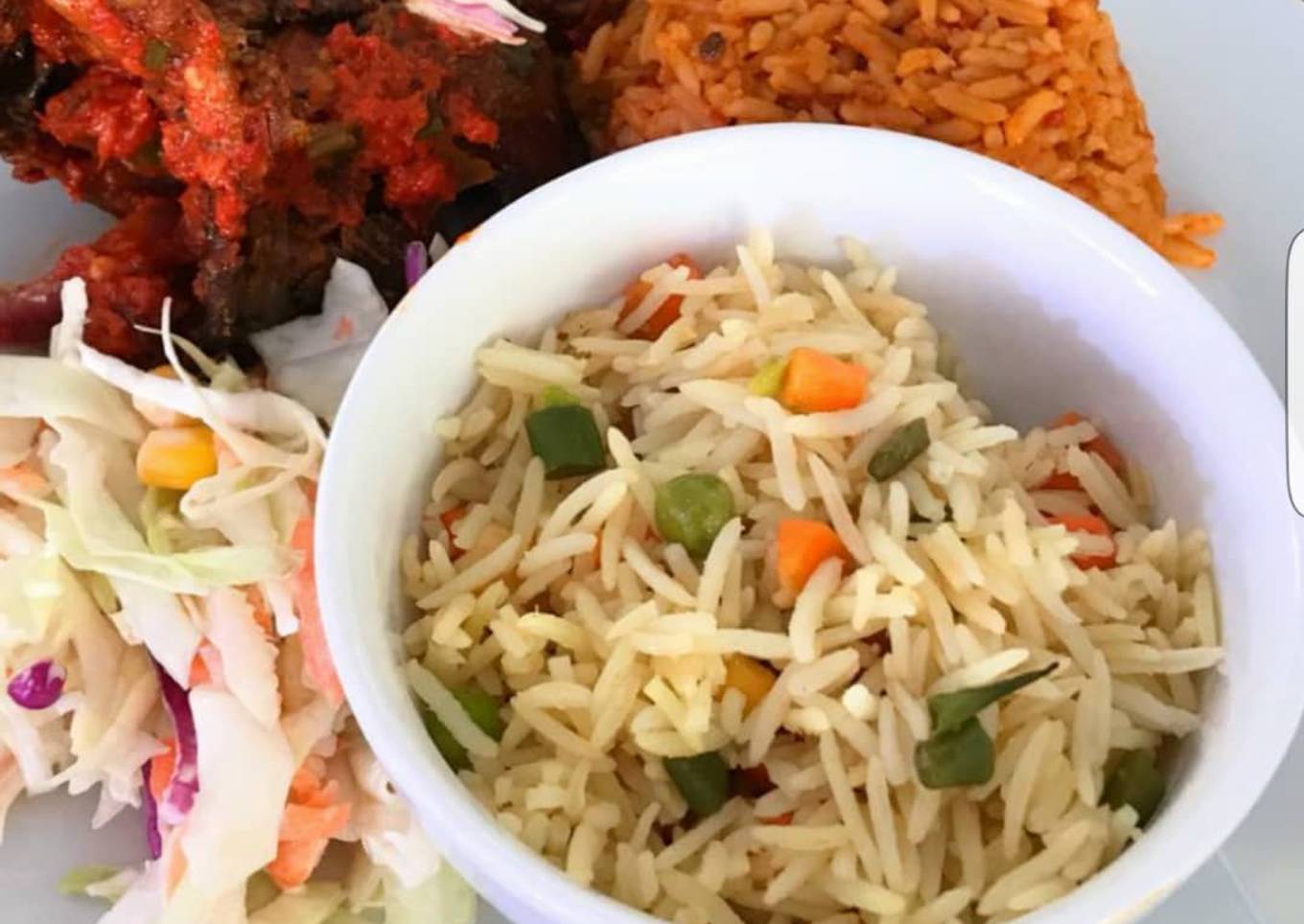 Jollof rice, fried rice, peppered chicken and coleslaw
