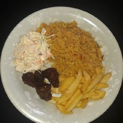 A picture of Jollof rice,chips, pepper meat n coleslaw.