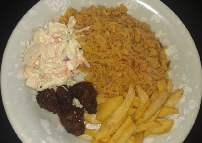 Jollof rice,chips, pepper meat n coleslaw