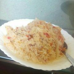 A picture of Fried rice served with cabbage.