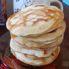 A picture of Fluffy Pancakes drizzled with honey.