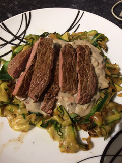 A picture of Mushroom and garlic sauce with courgette ribbons and pan fried steak.
