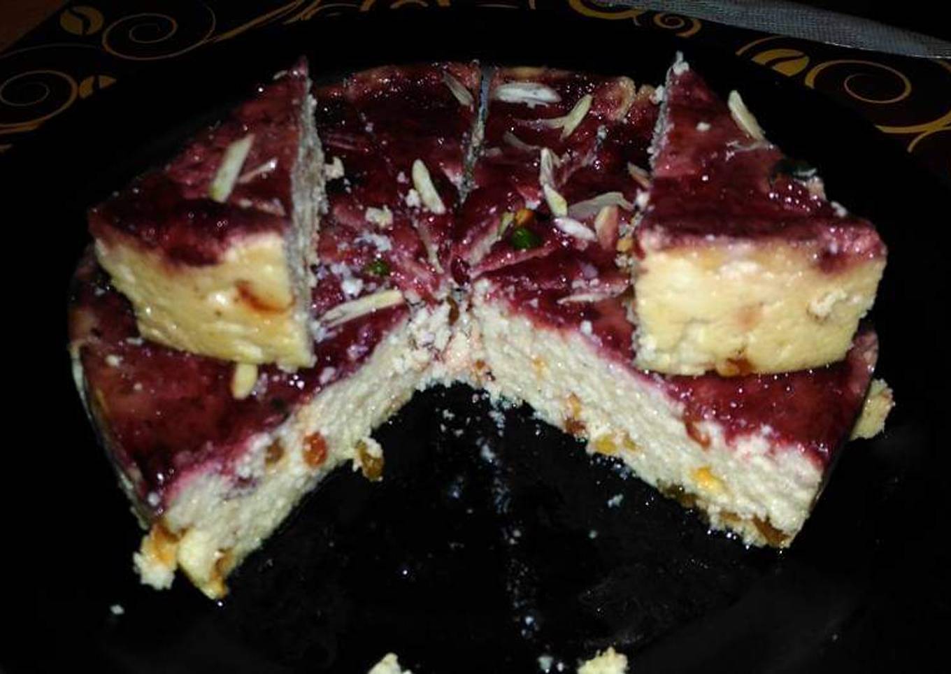 Steamed butterscotch sandesh with strawberry sauce