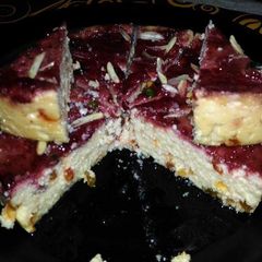 A picture of Steamed butterscotch sandesh with strawberry sauce.