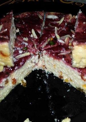 A picture of Steamed butterscotch sandesh with strawberry sauce.