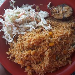A picture of Jollof rice with coslew.