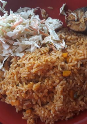 A picture of Jollof rice with coslew.