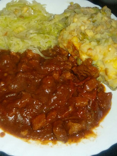 A picture of Beef stew (garam masala) with steamed cabbage and mukimo.