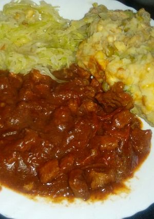 A picture of Beef stew (garam masala) with steamed cabbage and mukimo.