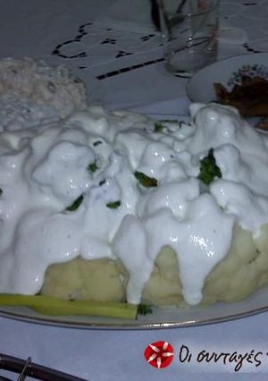 A picture of Cauliflower and broccoli with feta cheese sauce.
