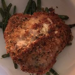 A picture of Herb crusted pork schnitzel with garlic parmesan green beans.