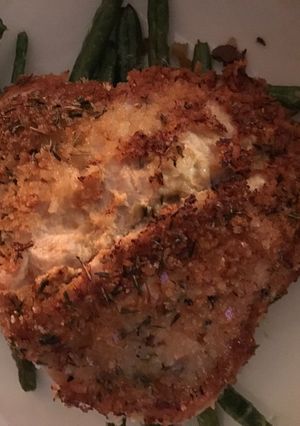 A picture of Herb crusted pork schnitzel with garlic parmesan green beans.