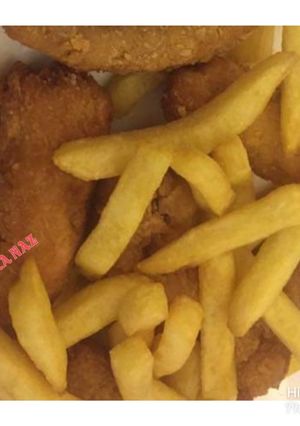 A picture of Chicken nuggets with french fries.