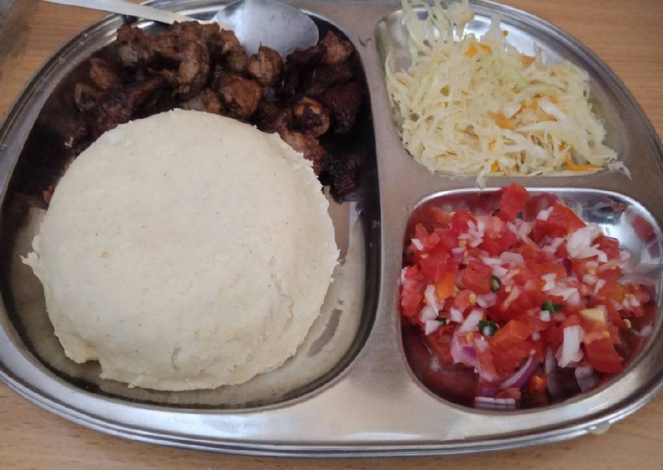 Fried Pork Ugali and cabbage and Kachumbari
