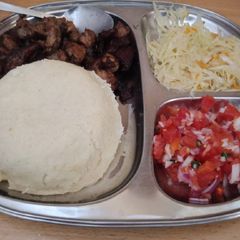 A picture of Fried Pork Ugali and cabbage and Kachumbari.