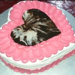 A picture of Heart shape cake with cocktail filling.