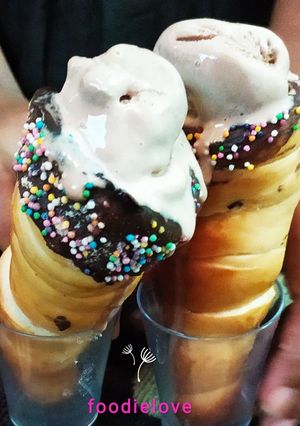A picture of Chocolate ganache cinnamon cones with icecream.