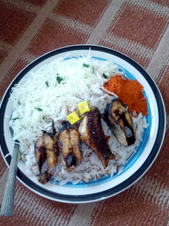 A picture of Rice n beans/fish n cabbage.