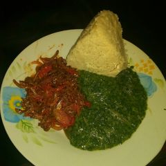 A picture of Omena fried, pumpkin leaves mixed with mrenda and ugali.
