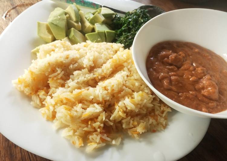 Carrot cumin rice served with peanut sauce and veggies