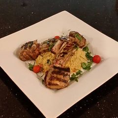 A picture of Grilled Lamb Chops with Parmesan Garlic Herb Couscous.