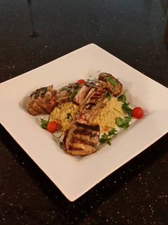 A picture of Grilled Lamb Chops with Parmesan Garlic Herb Couscous.