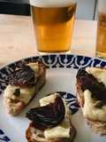 Tosta de queso curado con ciruela deshidratada y alcaparras